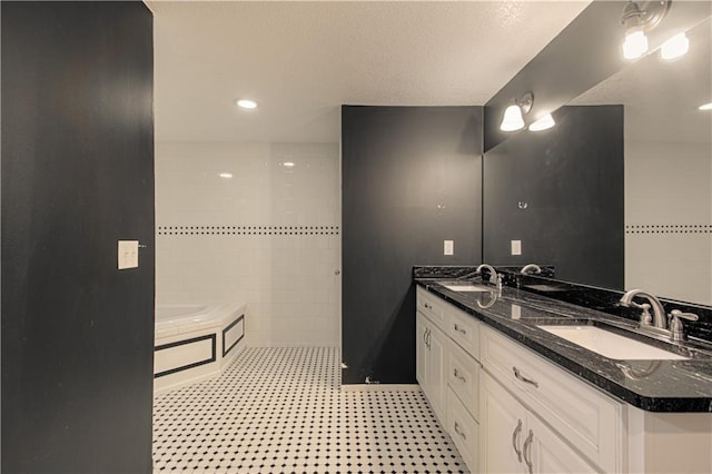 bathroom with a washtub and vanity