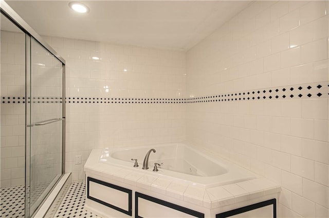 bathroom featuring shower with separate bathtub