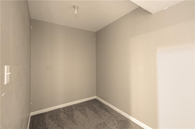 unfurnished room featuring carpet and a textured ceiling