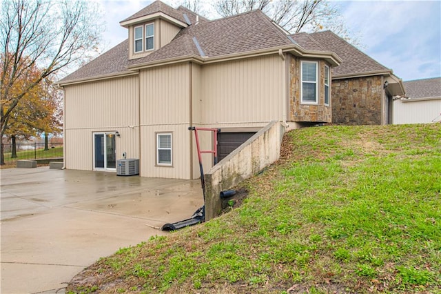 view of side of home with central AC unit and a patio area