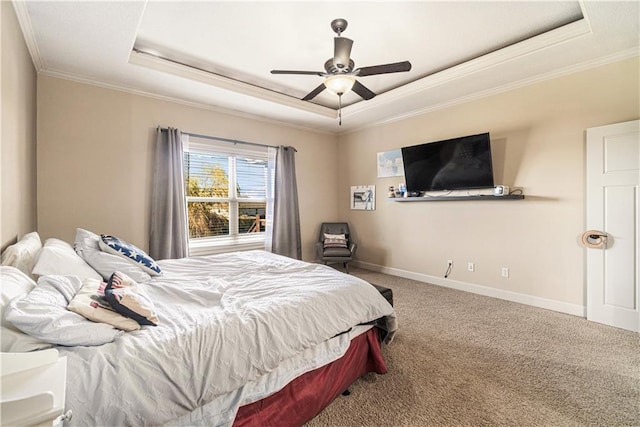 carpeted bedroom with crown molding, ceiling fan, and a tray ceiling