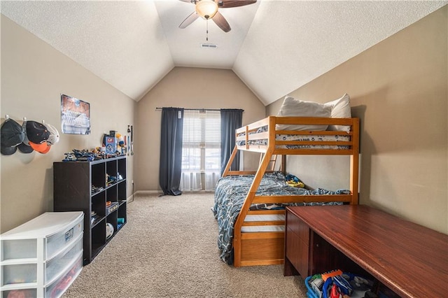 bedroom featuring ceiling fan, lofted ceiling, light carpet, and a textured ceiling