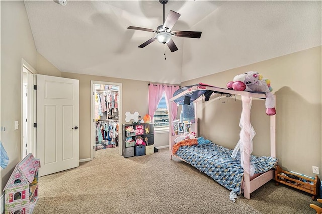 bedroom featuring lofted ceiling, ceiling fan, carpet, a walk in closet, and a closet