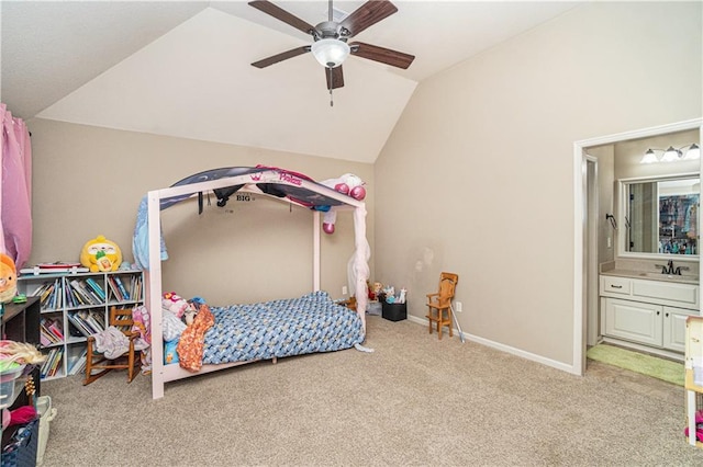 bedroom featuring ceiling fan, lofted ceiling, light colored carpet, and ensuite bath