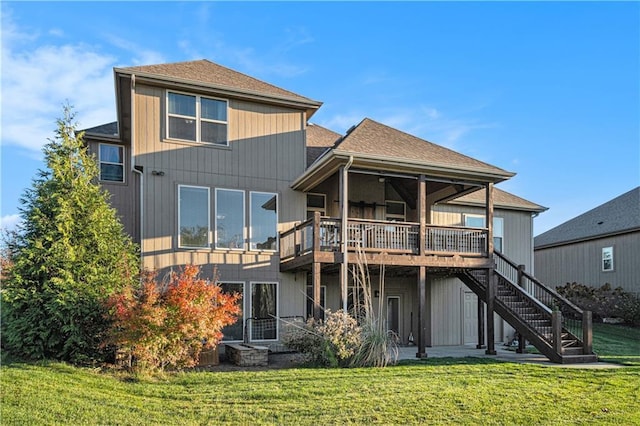 back of house with a wooden deck and a lawn