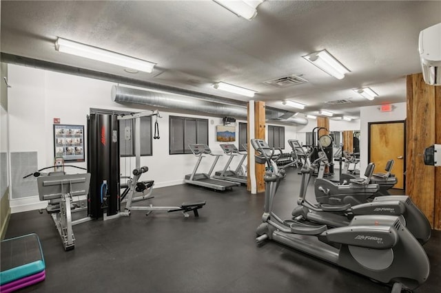 exercise room with a textured ceiling