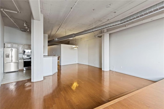 unfurnished living room with wood-type flooring