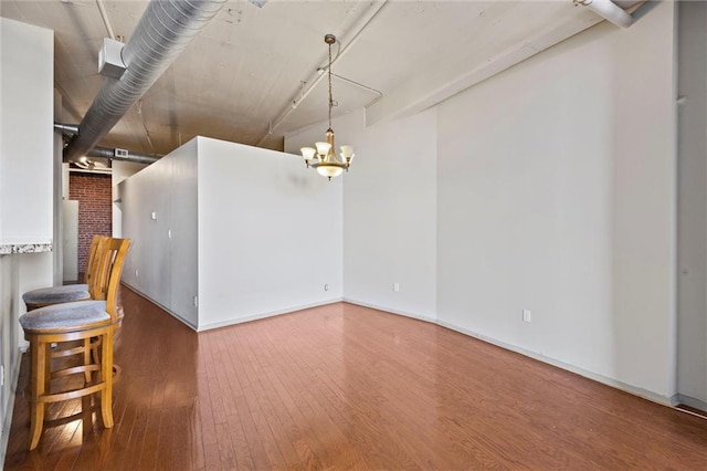 interior space with hardwood / wood-style floors and a notable chandelier