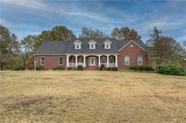 cape cod-style house with a porch and a front lawn