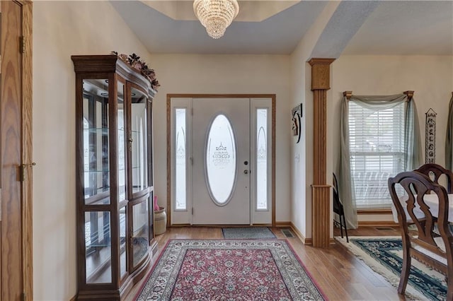 entrance foyer featuring a notable chandelier and light hardwood / wood-style flooring