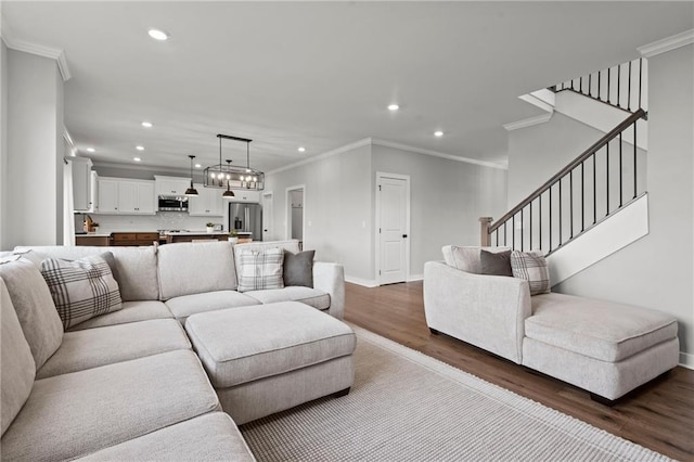 living room with hardwood / wood-style floors and ornamental molding