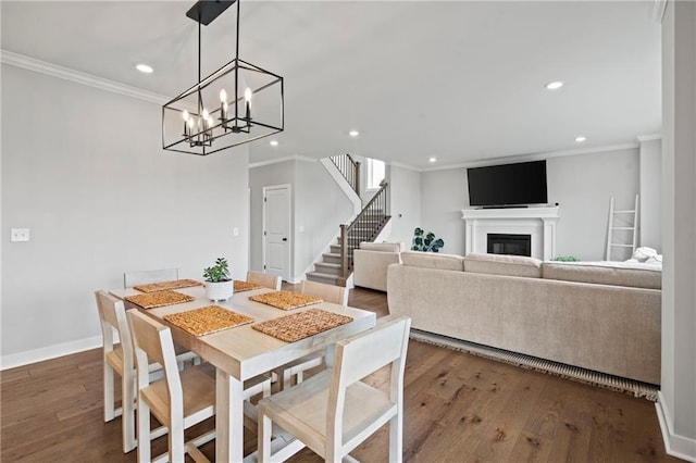 dining room featuring dark wood-type flooring and crown molding