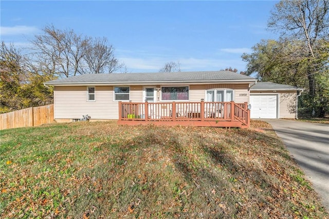 single story home featuring a wooden deck, a front yard, and a garage