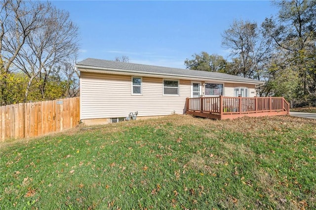 back of house featuring a yard and a wooden deck