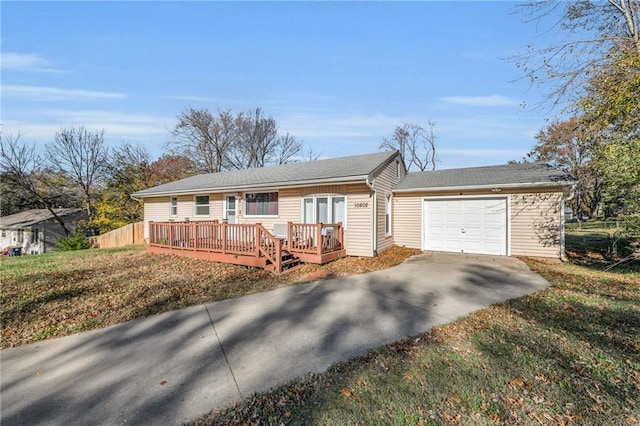 ranch-style home with a deck, a front lawn, and a garage