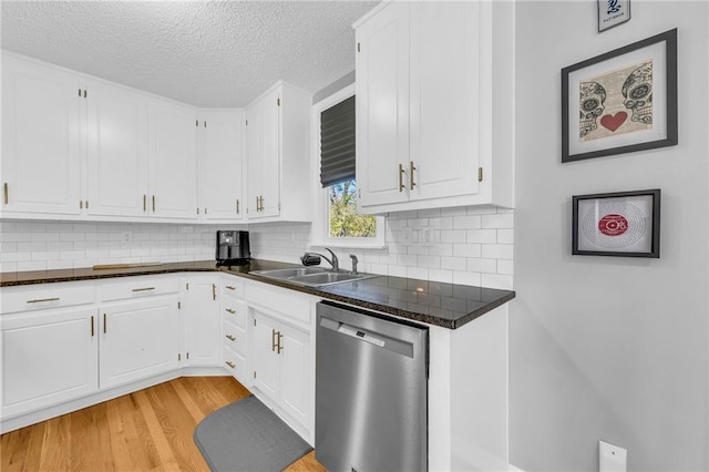 kitchen featuring white cabinetry, dishwasher, and sink