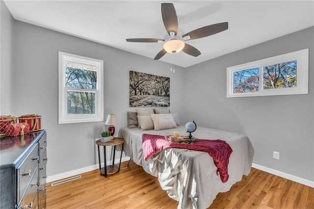 bedroom with ceiling fan and light hardwood / wood-style floors