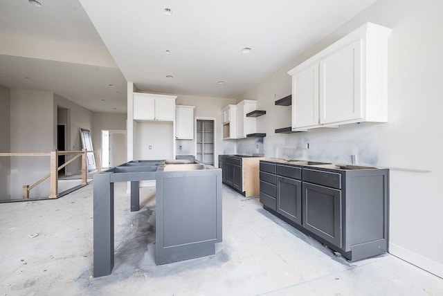 kitchen featuring white cabinetry, a kitchen island, and gray cabinetry