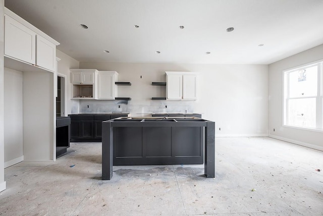 kitchen featuring a kitchen island and white cabinets