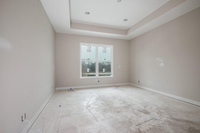 unfurnished room featuring a tray ceiling