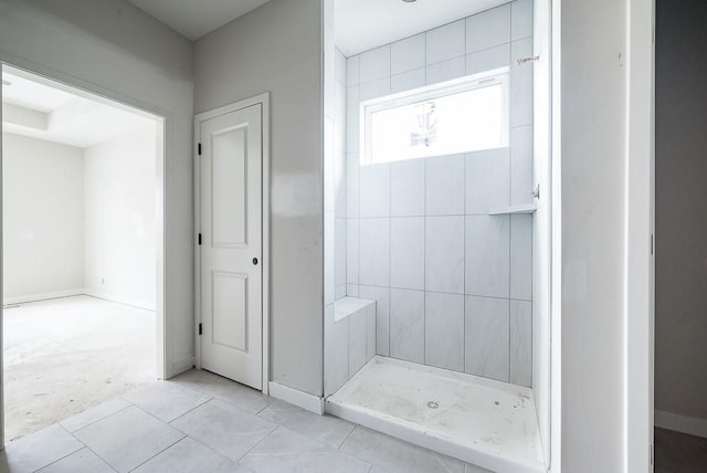 bathroom with tiled shower