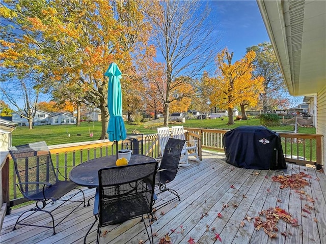 deck featuring a lawn and area for grilling