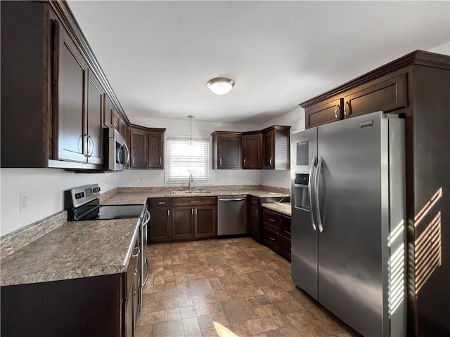 kitchen with hanging light fixtures, dark brown cabinets, sink, and stainless steel appliances