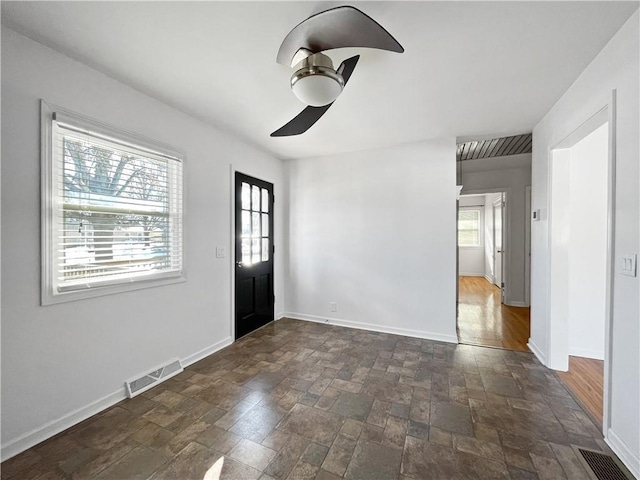 interior space with ceiling fan and a wealth of natural light