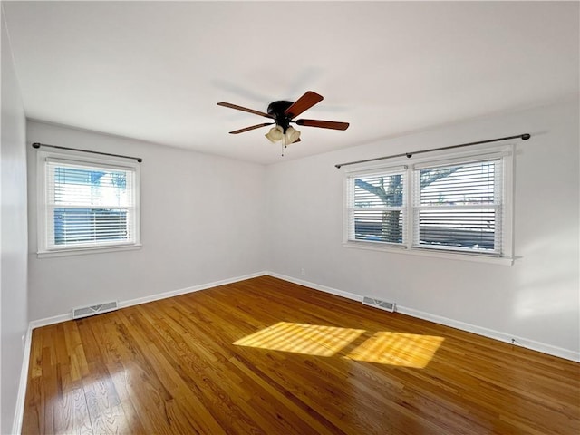 unfurnished room with ceiling fan and wood-type flooring