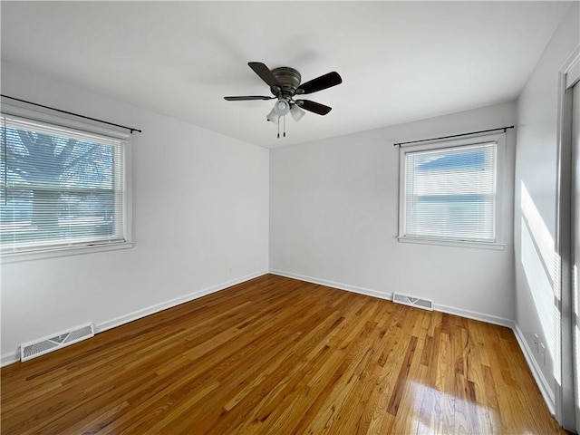 empty room featuring ceiling fan and light hardwood / wood-style flooring