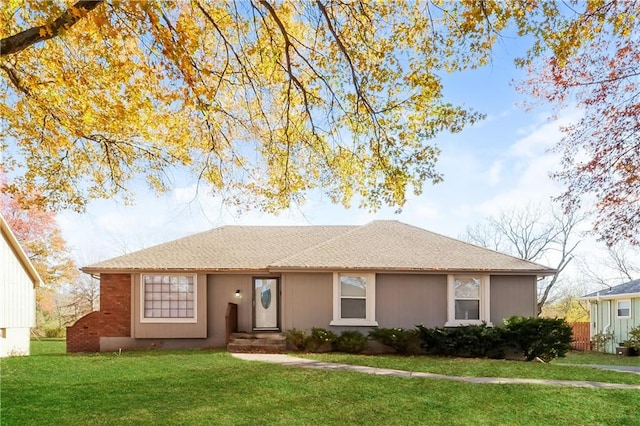 ranch-style home with a front lawn