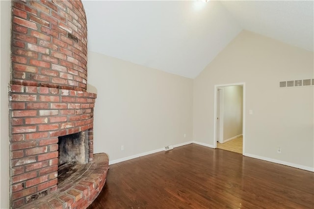 unfurnished living room featuring high vaulted ceiling, a brick fireplace, and dark wood-type flooring