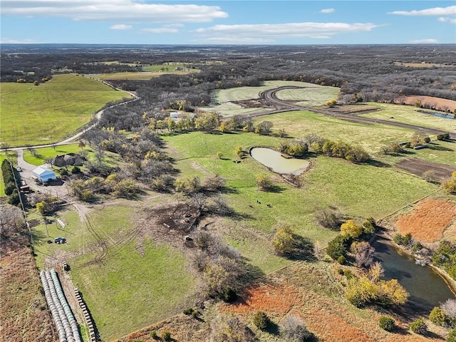 birds eye view of property with a rural view