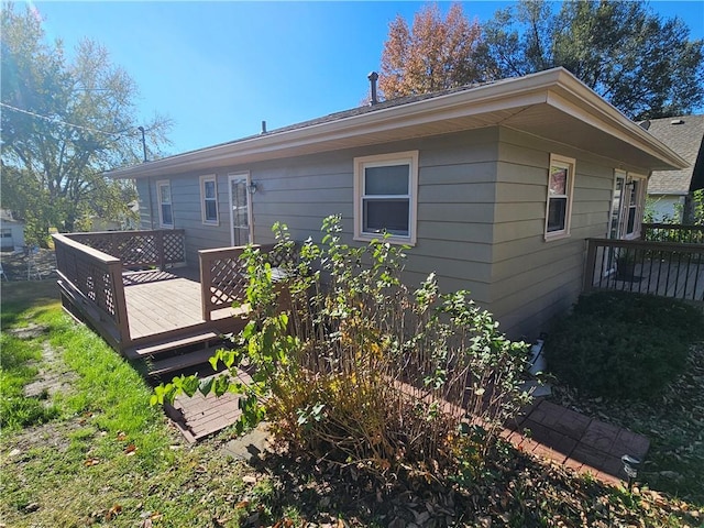 rear view of property featuring a deck