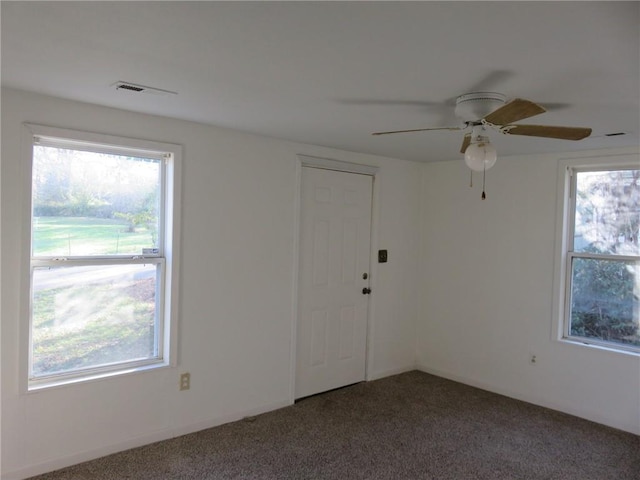 empty room featuring ceiling fan and carpet floors