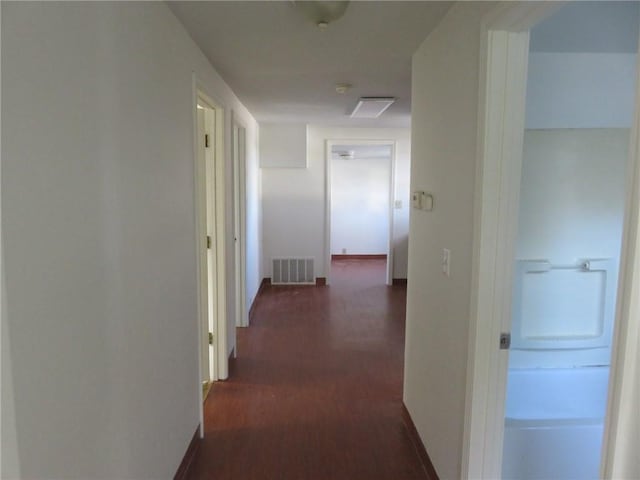 1002 S Haden St, Independence, MO 64050 - hall with dark wood-style flooring and baseboards