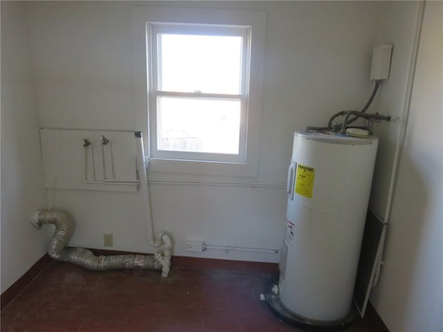 1002 S Haden St, Independence, MO 64050 - laundry area featuring electric water heater and plenty of natural light
