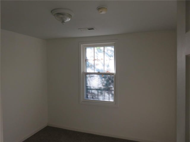 1002 S Haden St, Independence, MO 64050 - spare room with baseboards and dark carpet