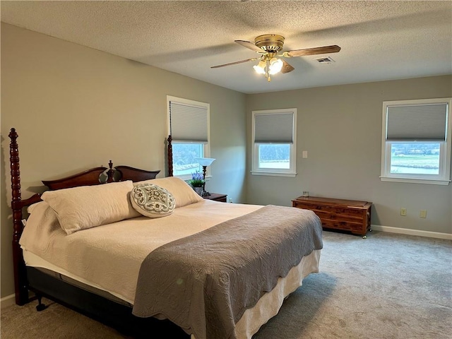 bedroom with carpet, a textured ceiling, and ceiling fan