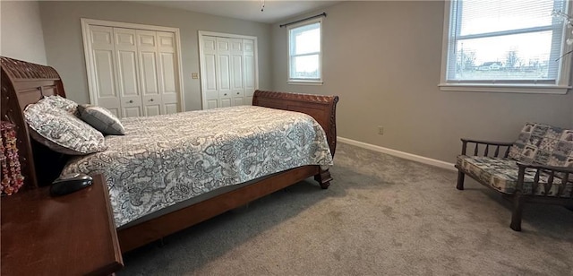 carpeted bedroom featuring two closets