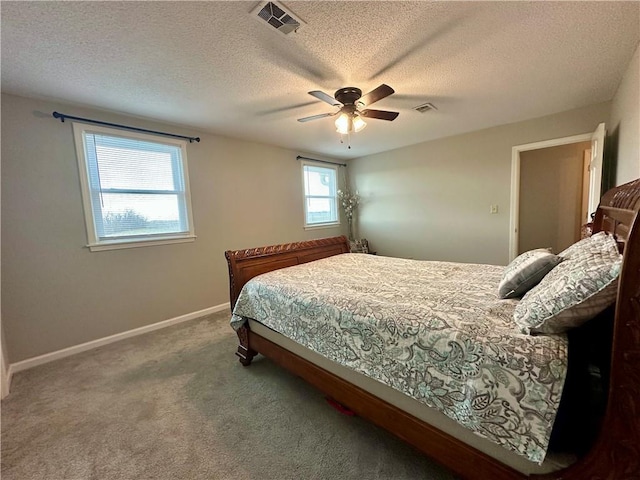 bedroom with carpet flooring, ceiling fan, and a textured ceiling