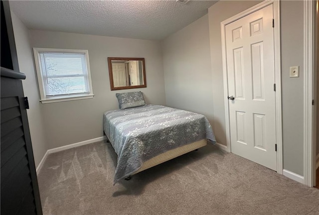 carpeted bedroom featuring a textured ceiling