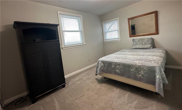 bedroom featuring carpet floors and a textured ceiling