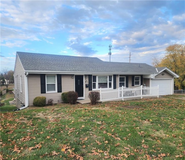 ranch-style house with a garage and a front lawn