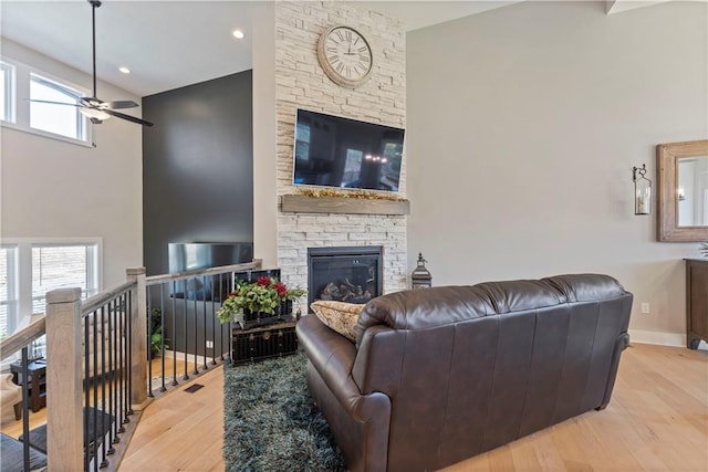 living room with ceiling fan, a healthy amount of sunlight, and light hardwood / wood-style floors