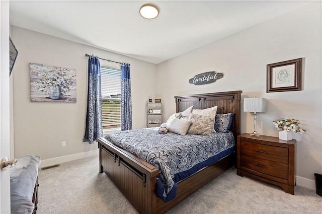 bedroom featuring light colored carpet