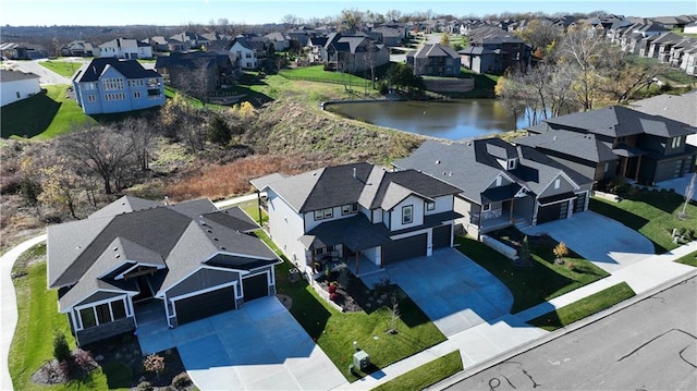 birds eye view of property with a water view