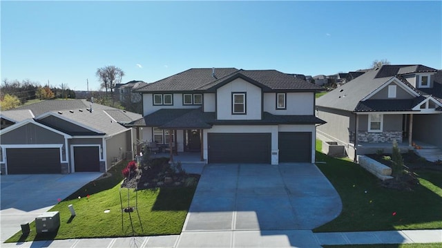 front of property featuring a front yard, a garage, and cooling unit