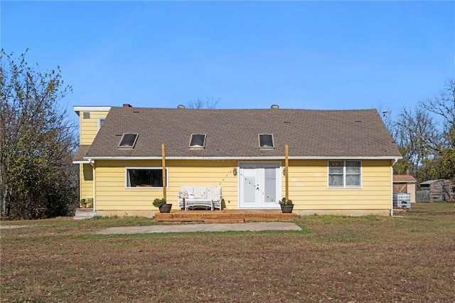 rear view of property featuring a yard and french doors