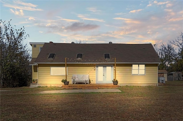 back house at dusk with a yard